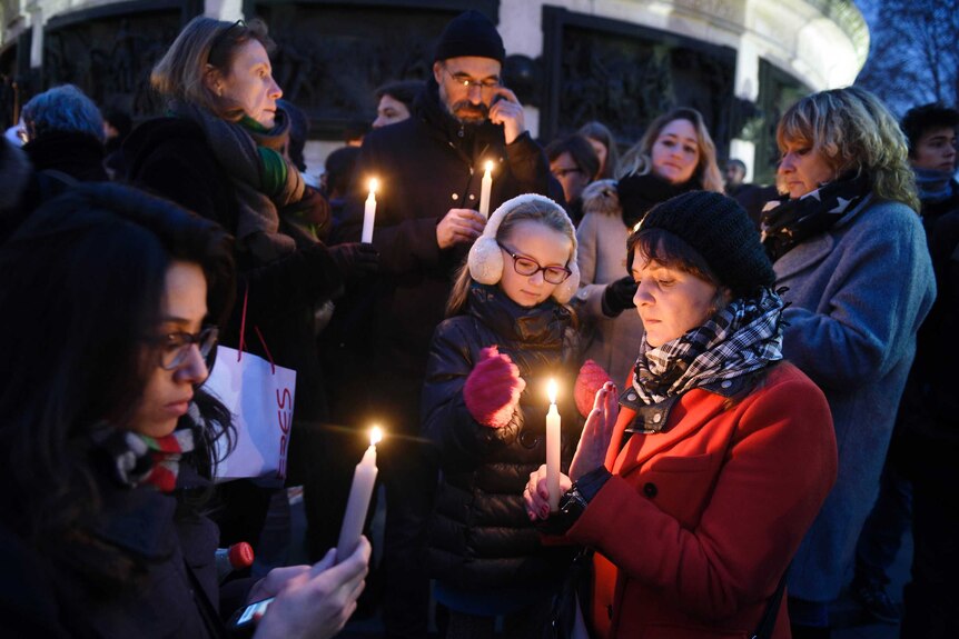 People light candles during a rally in support of the victims of the attack in Paris.