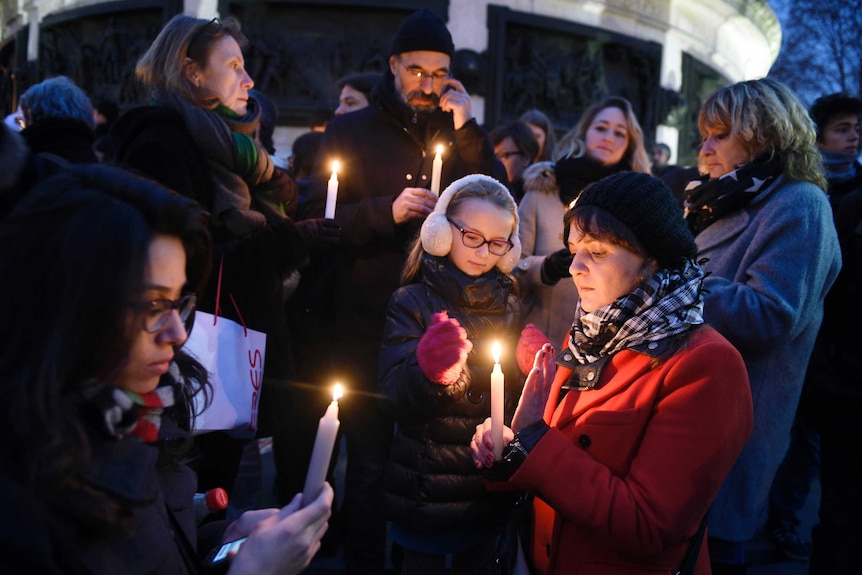 People light candles during a rally in support of the victims of the attack by gunmen at French satyrical newspaper Charlie Hebdo