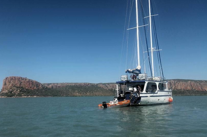 A yacht at anchor on blue water