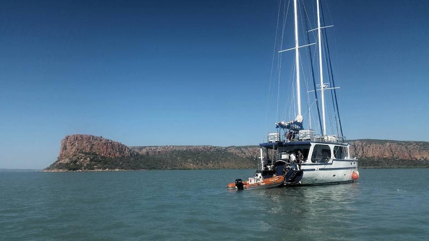 A yacht at anchor on blue water