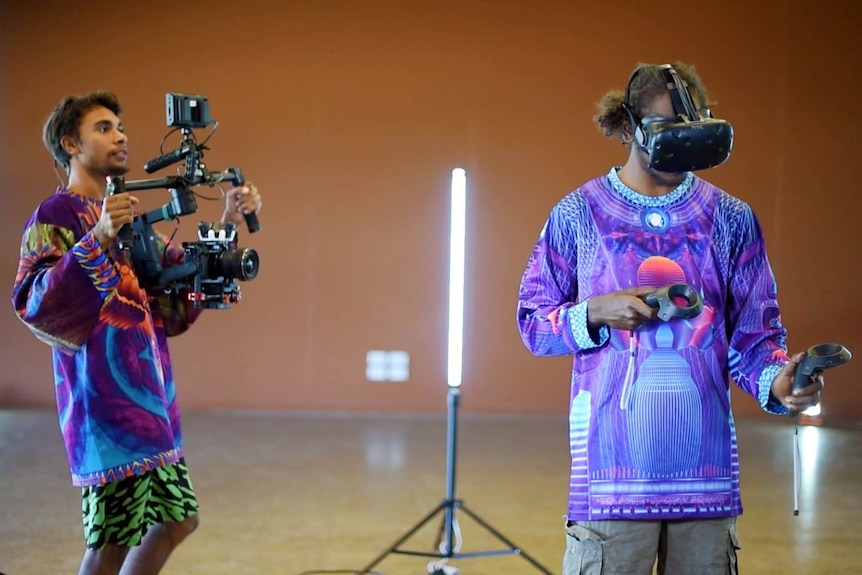 Young men using virtual reality technology including headgear and controllers.