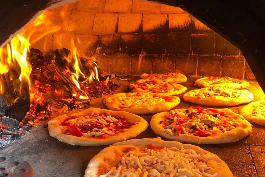 Pizzas in a wood fired oven.