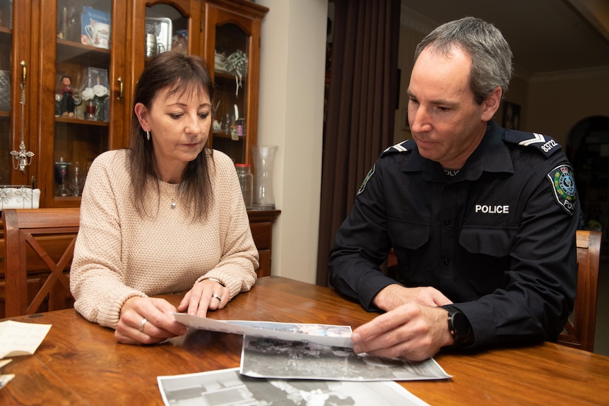 Woman sitting with a Senior Constable at a dining table.