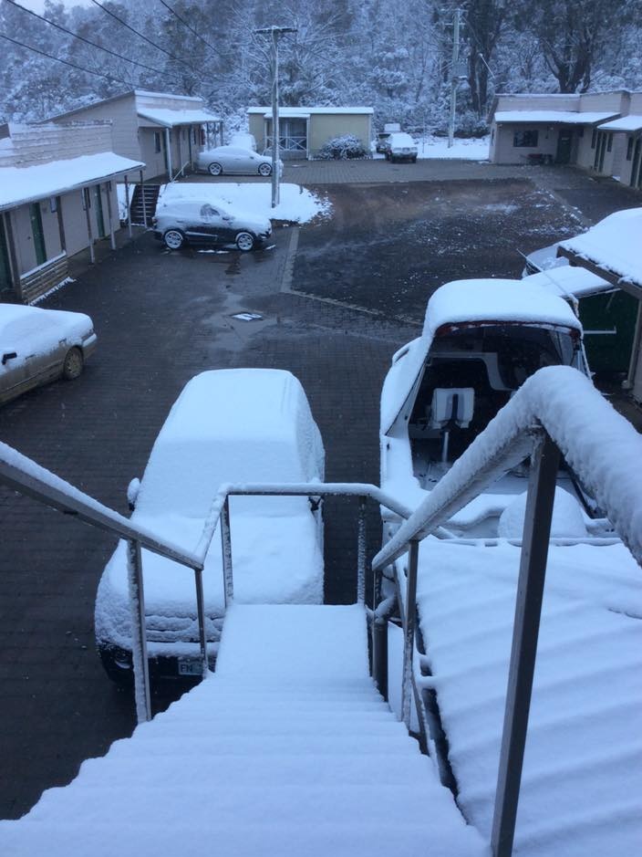 Snow on cars and the steps of the Great Lake Hotel in Tasmania's Central Highlands