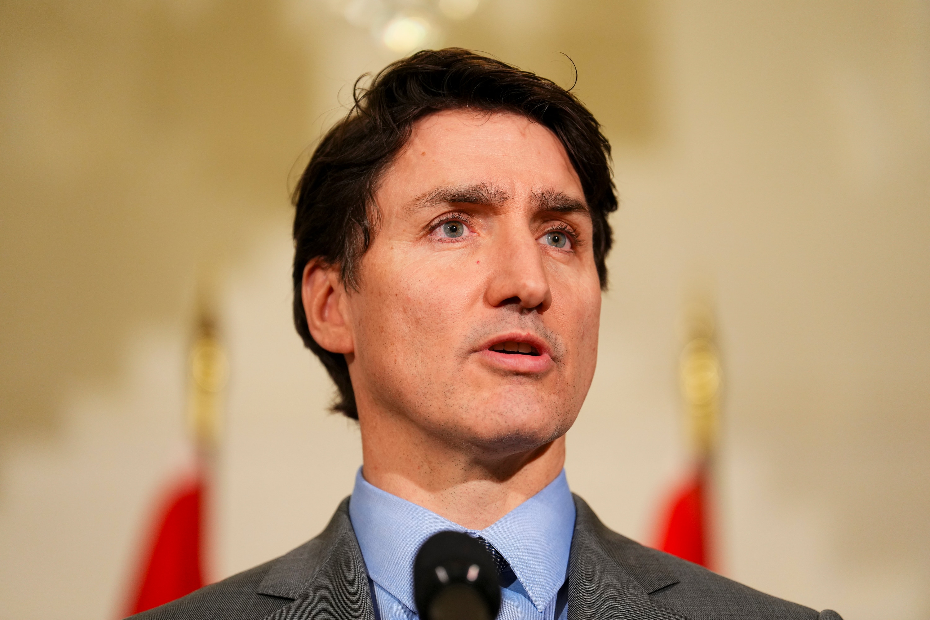 Justin Trudeau speaks at a press conference indoors.