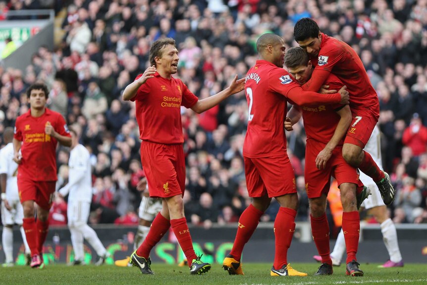 Off and away ... Steven Gerrard scores Liverpool's first of five against Swansea from the penalty spot.