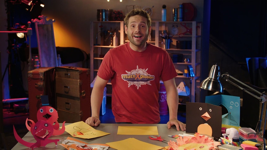 Man stands in front of table with folder paper objects