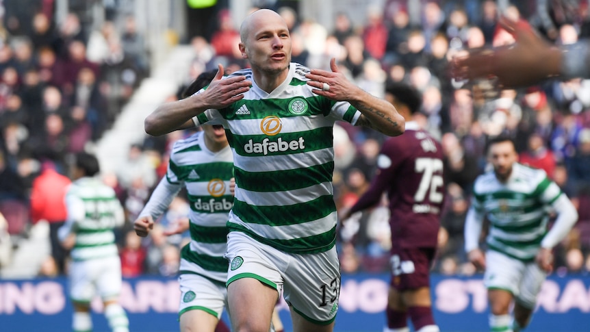Celtic's Aaron Mooy blows a kiss to the crowd as he runs away in celebration after scoring a goal. 