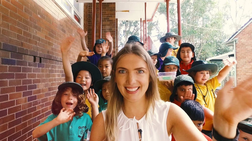 A picture of a teacher with her students