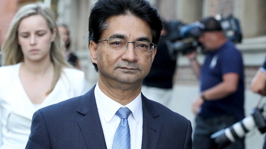 A tight mid shot of Lloyd Rayney walking outside court.