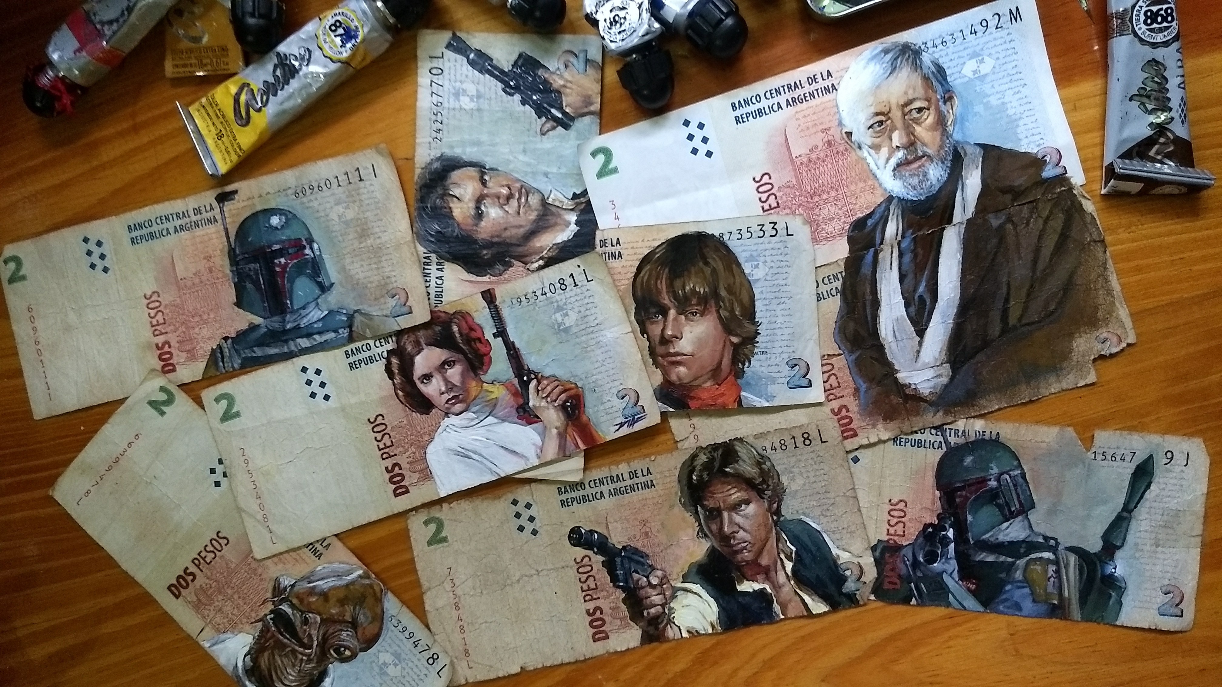 A pile of peso banknotes with Star Wars characters painted on them.