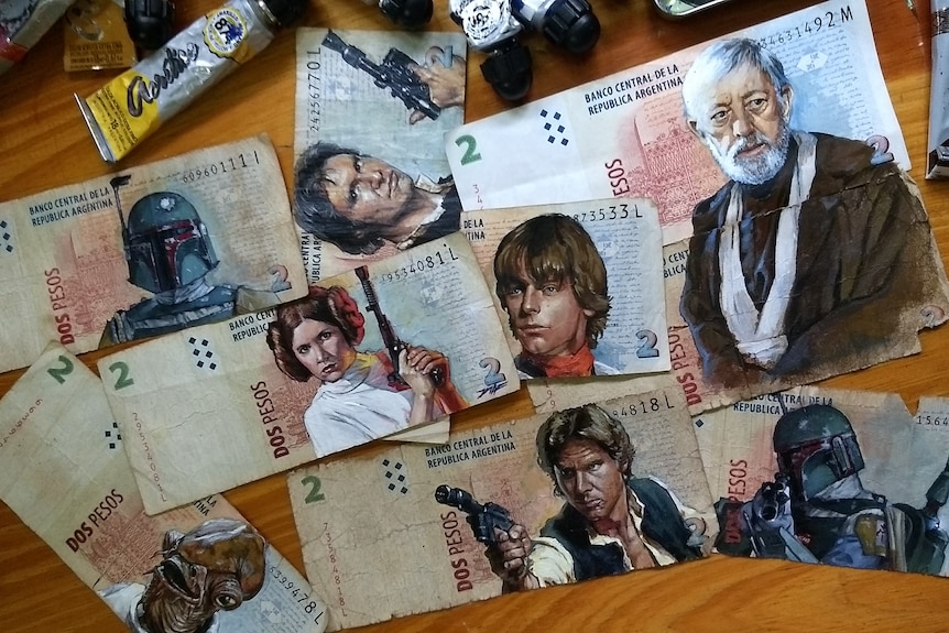 A pile of peso banknotes with Star Wars characters painted on them.