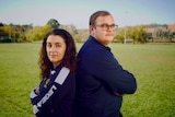 Defline and Hamish stand back to back on a soccer pitch in canberra.