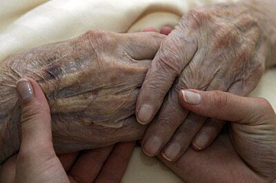 Aged hands and carer's hands