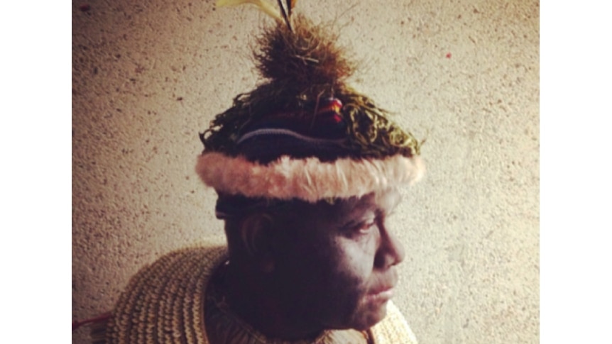 Profile picture of a man wearing traditional dress.