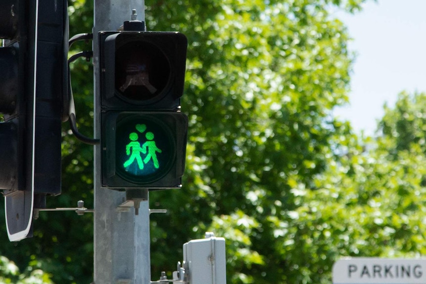 A same-sex male couple on a Canberra pedestrian light