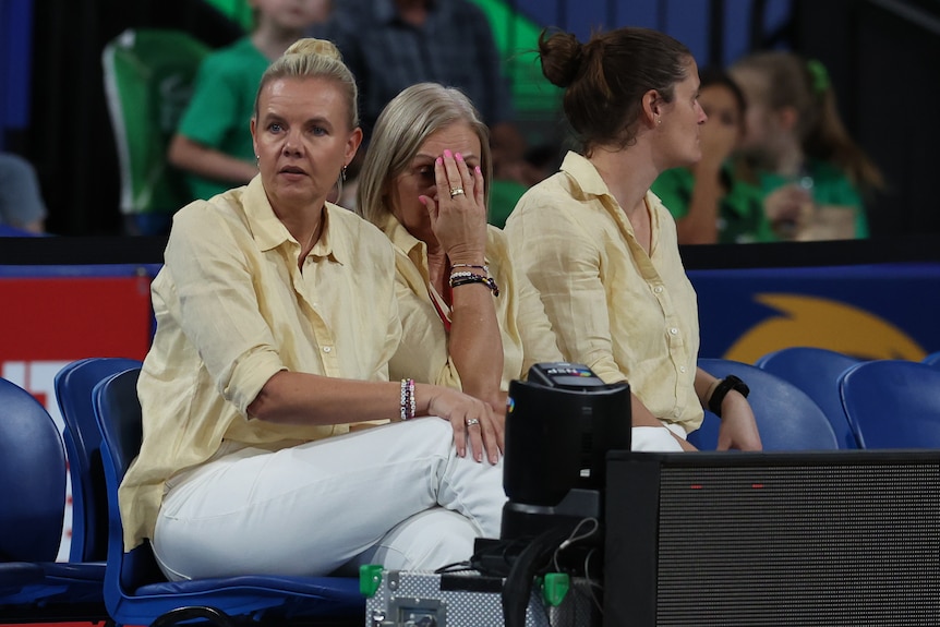 Belinda Reynolds watches her team from the sideline as the Lightning assistant covers her face with her hand