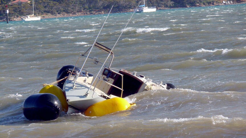 Rough seas batter a boat that broke its moorings at Port Lincoln