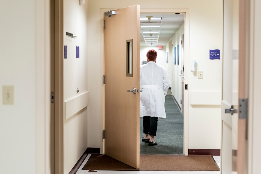 A woman walking down a hall.