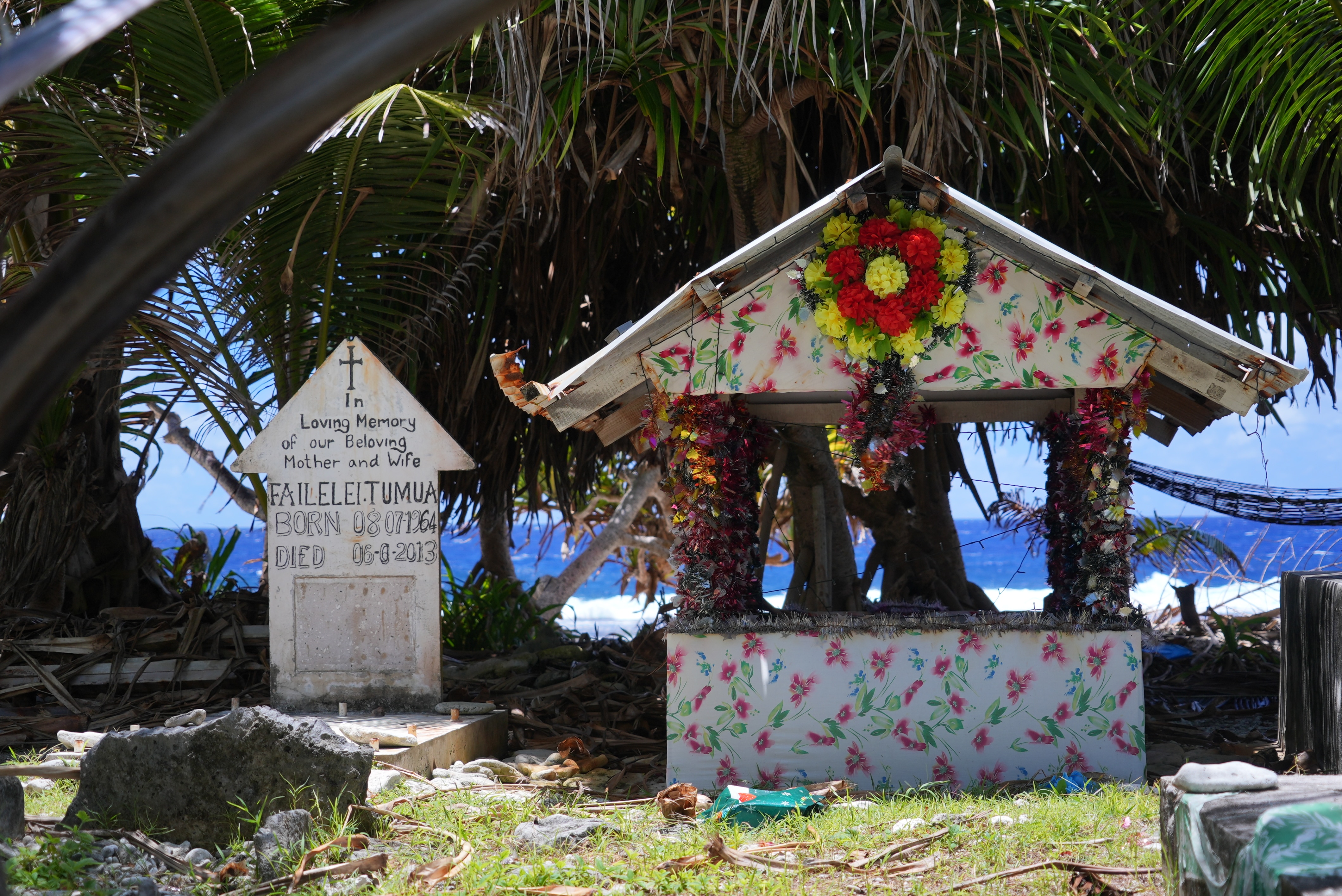 A photo of two gravestones with a backdrop of the sea.