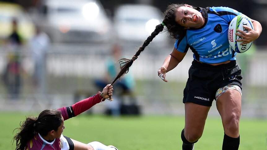 Maryoly Gamez pulls Victoria Rios' hair druing an International Womens Rugby Sevens match in Rio.