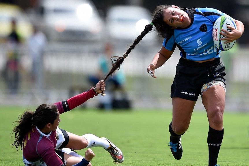 Maryoly Gamez pulls Victoria Rios' hair druing an International Womens Rugby Sevens match in Rio.