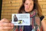 Ellen Fraser-Barbour shows her guide dog owner's identification card.
