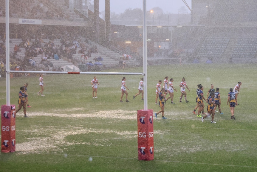 The rain falls on Wollongong Showground during a women's rugby league match 