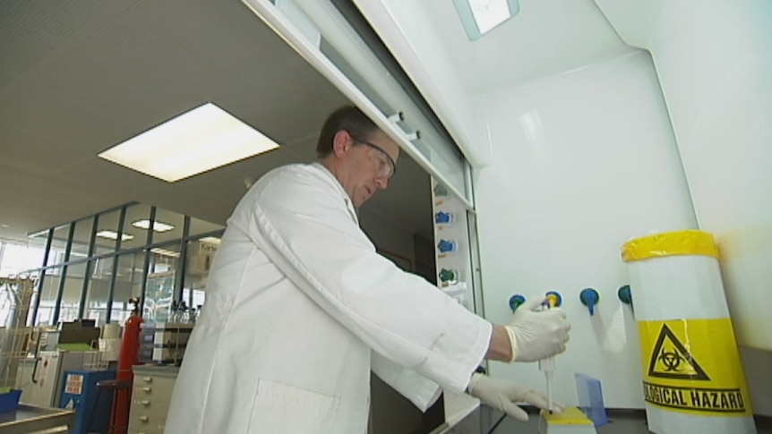 Dr Glenn Jacobson from the University of Tasmania's School of Medicine with test tubes.