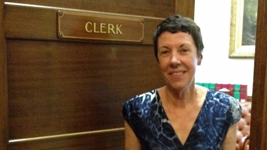 Clerk of the Upper House since 1992, Jan Davis stands in front of the door to her office.