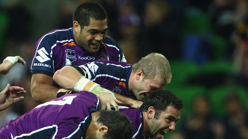 Try time ... Jesse Bromwich is congratulated by his Storm team-mates
