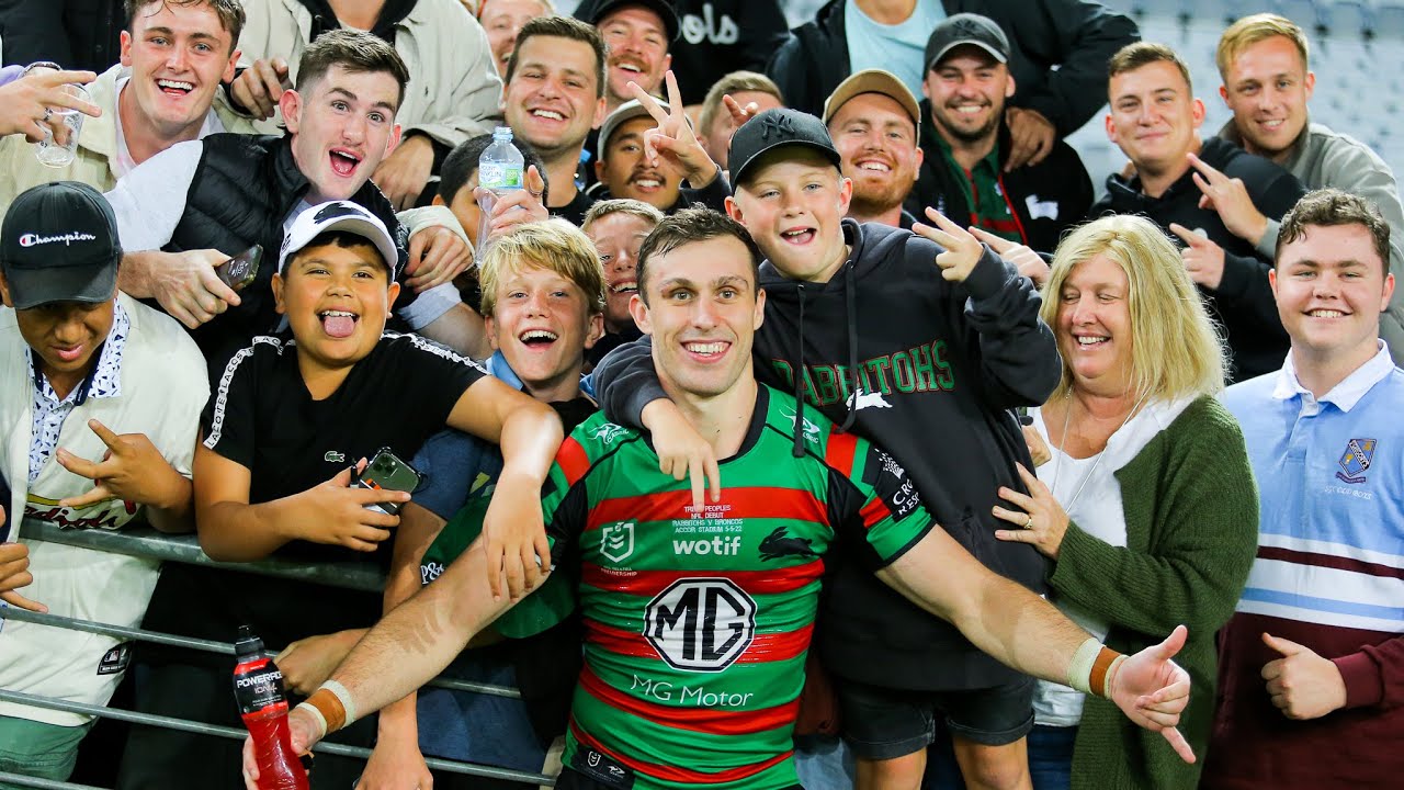 A man celebrates with family and friends after a rugby league match