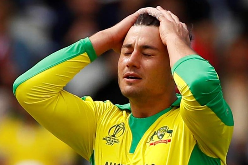 Australia bowler Marcus Stoinis puts his hands on his head and closes his eyes during a Cricket World Cup match.