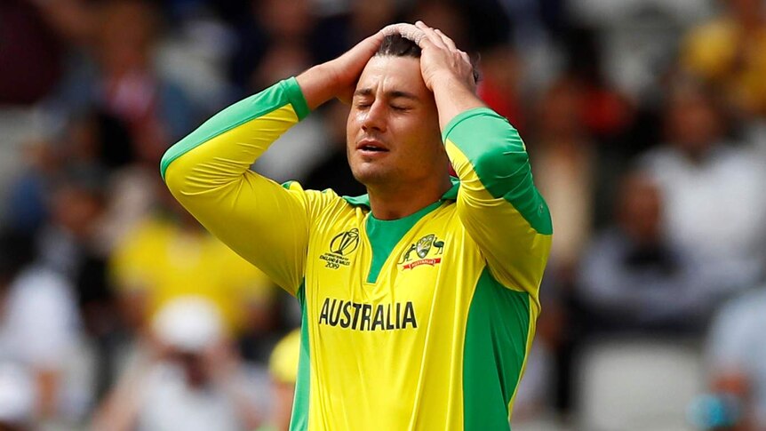 Australia bowler Marcus Stoinis puts his hands on his head and closes his eyes during a Cricket World Cup match.