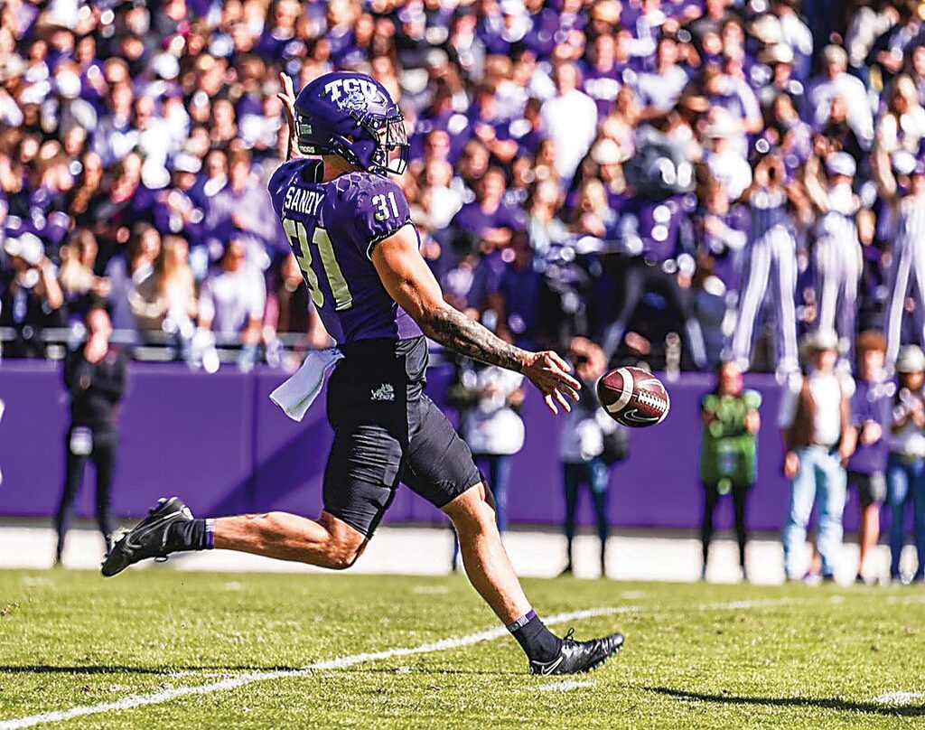 American football player kicking a ball