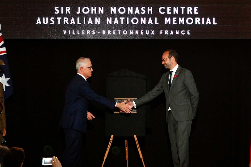 French Prime Minister Edouard Philippe (right) and Malcolm Turnbull unveil a plaque.