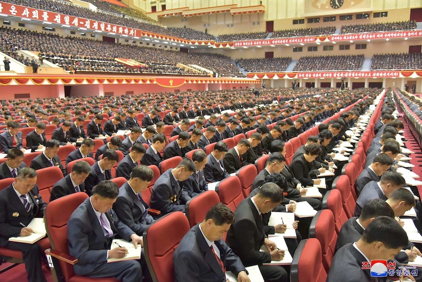 Attendees take notes at the Workers' Party of Korea conference