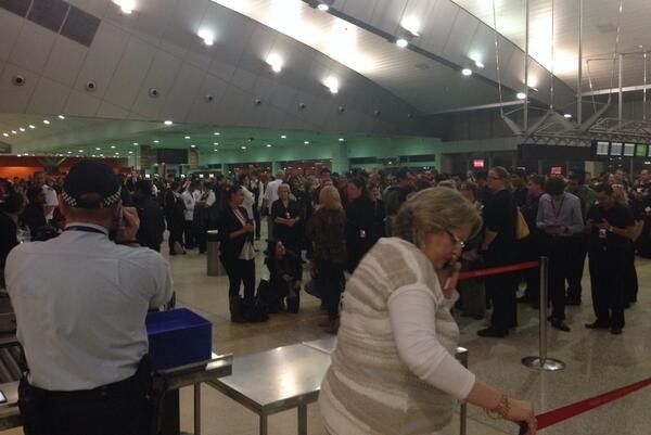 Passengers wait at Melbourne Airport after security breach