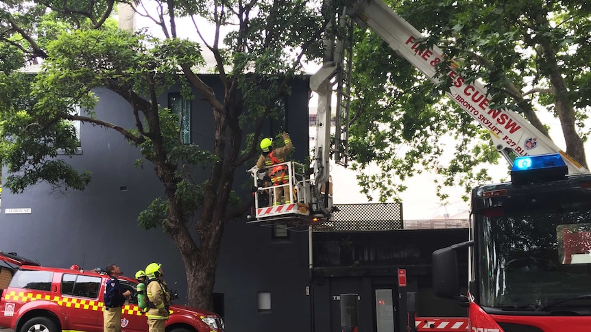 Firefighters outside terrace house after blaze at property in Sydney