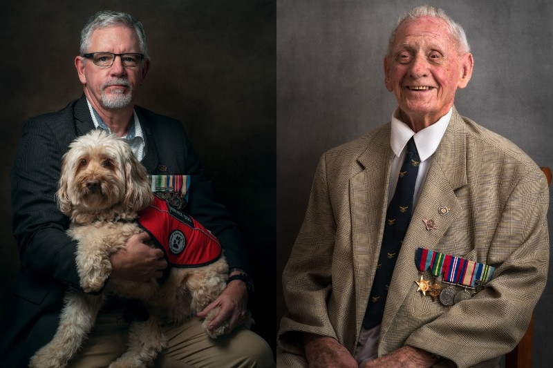 A veteran with a service dog in his lap, next to an old veteran in a suit with service medals