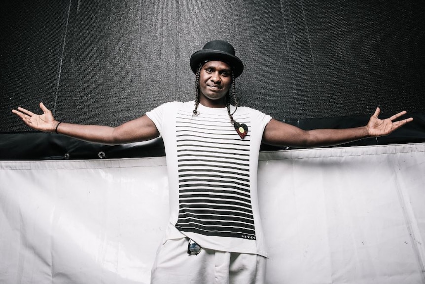 Rapper and dancer Baker Boy arms out in front of a black and white backdrop