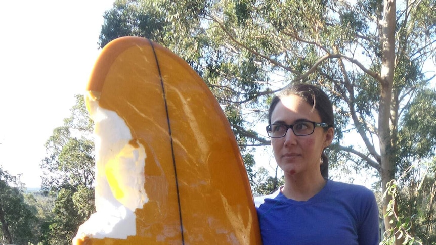 Shark attack victim Lily Kumpe with her damaged surfboard