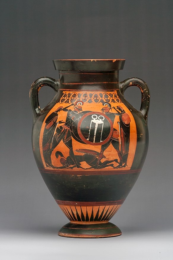 A black ancient Greek amphora with an illustration of warriors.