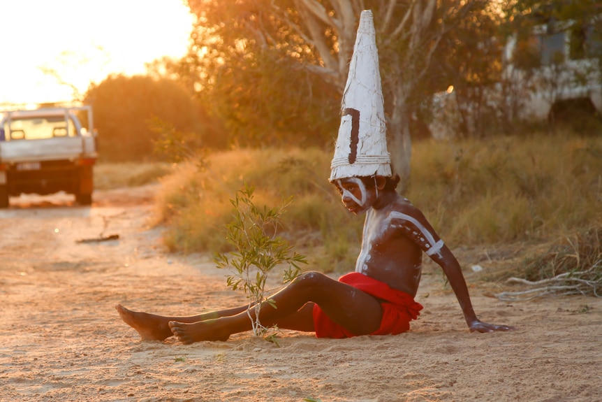 A young Mowanjum dancer rests after a rehearsal