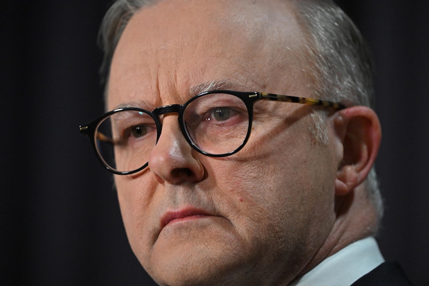 Anthony Albanese looks solemn in a close-up shot.
