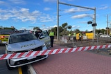 The scene of a train and cyclist crash at a train crossing.