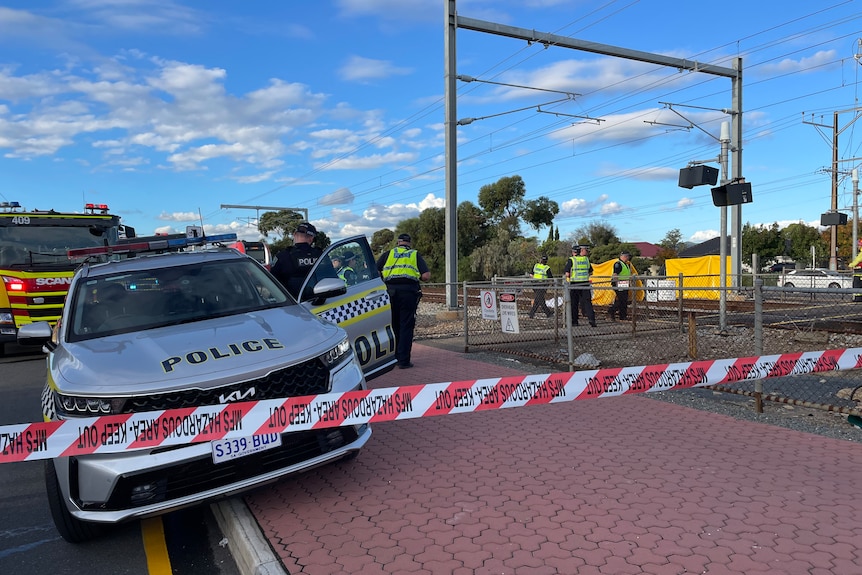 The scene of a train and cyclist crash at a train crossing.
