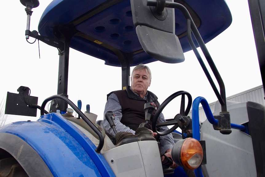 Image of a man sitting on a tractor.