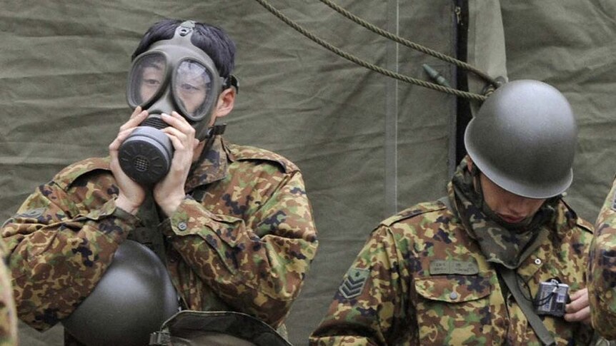 Japanese soldiers prepare for work in a radiation-affected area in Nihonmatsu, Fukushima Prefecture in northern Japan