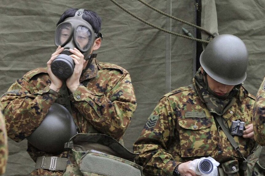 Japanese soldiers prepare for work in a radiation-affected area in Nihonmatsu, Fukushima Prefecture in northern Japan